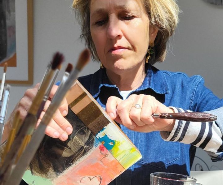 Loes bekijkt een werk in haar atelier